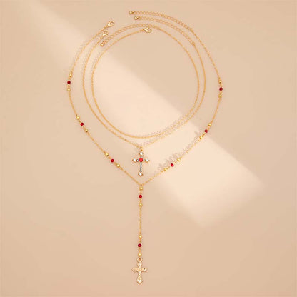Colliers superposés avec croix dorées pour femme